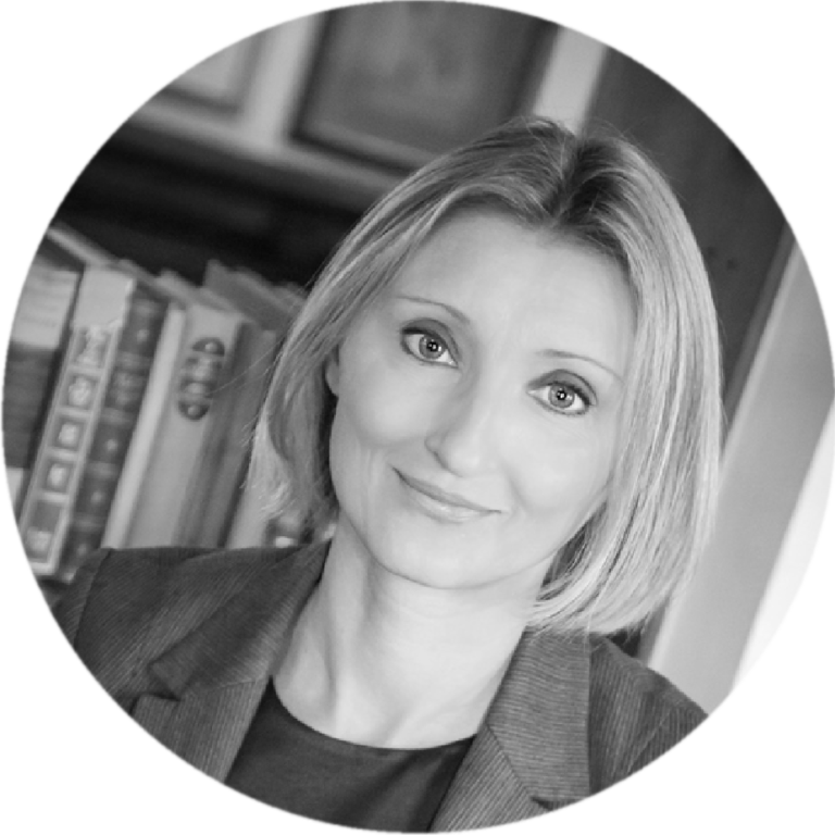 A photograph of Kate Hurry in black and white with a bookshelf in the background